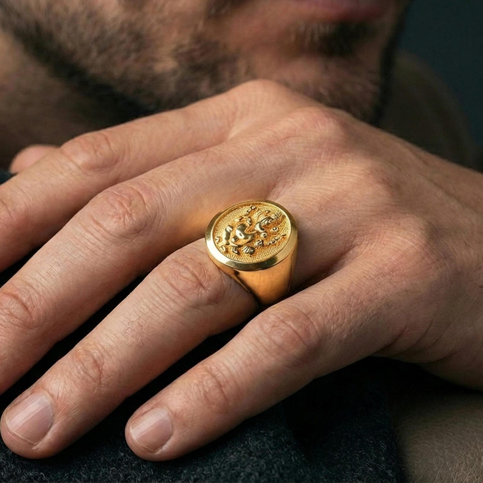 Gold plated Ganesha signet ring worn on finger, Hindu spiritual elephant deity ring with raised relief and bold signet style