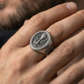 Load image into Gallery viewer, Oxidized 925 sterling silver Holy Eucharist signet ring worn on finger, chalice and host engraving with cross band detail
