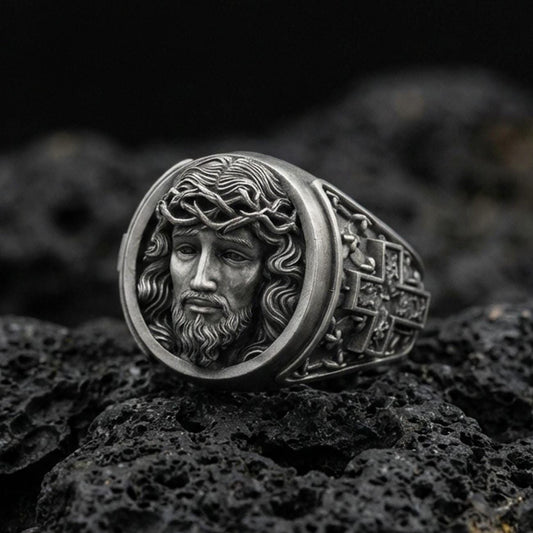 Oxidized 925 sterling silver Jesus ring on volcanic rock, crown of thorns portrait relief with deep antiqued shadows