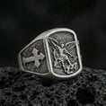 Load image into Gallery viewer, Oxidized 925 sterling silver Archangel Michael ring on volcanic rock, Michael slaying demon relief with cross side motif
