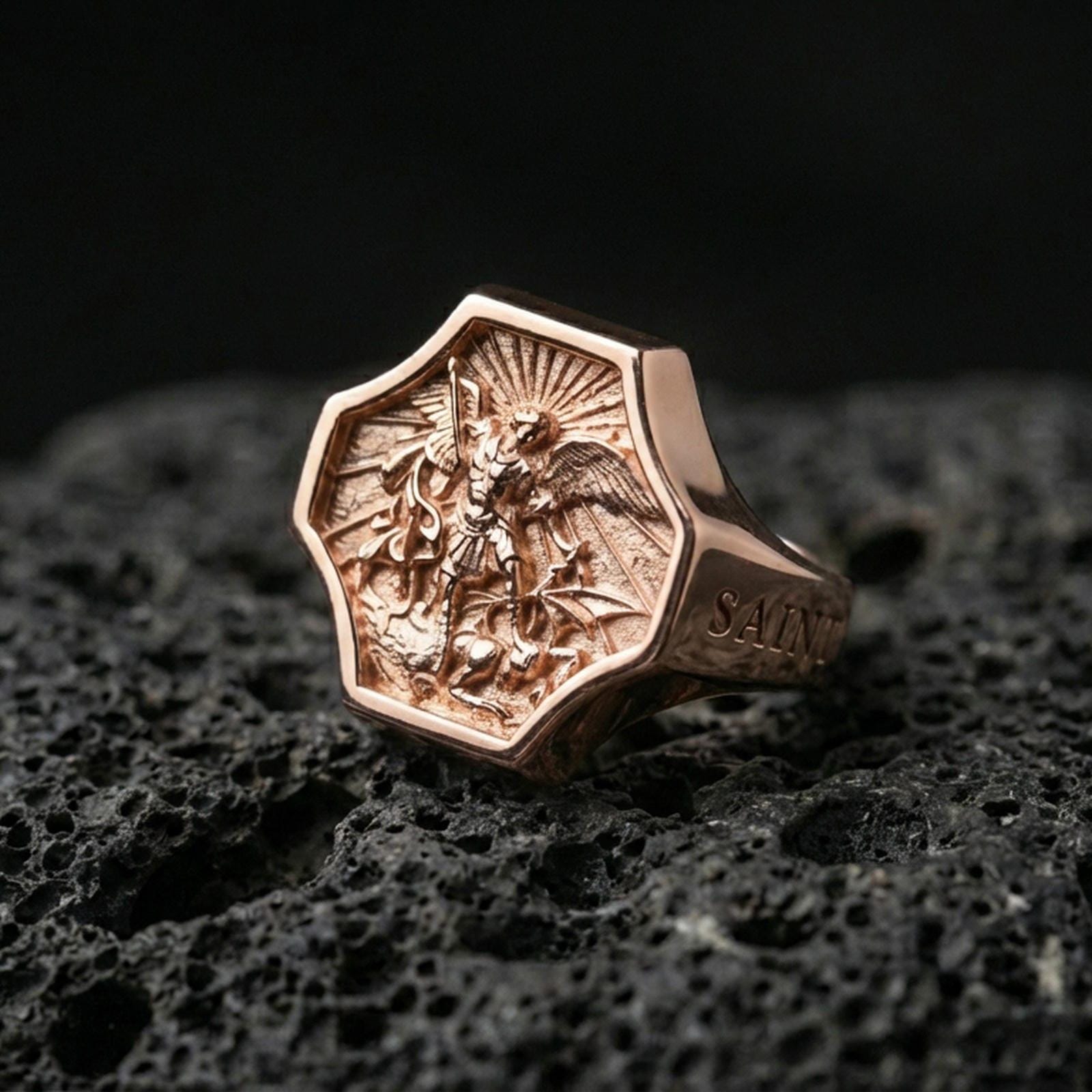 Rose gold plated Saint Michael signet ring on volcanic stone, octagon face angel battle relief with warm luxury tone