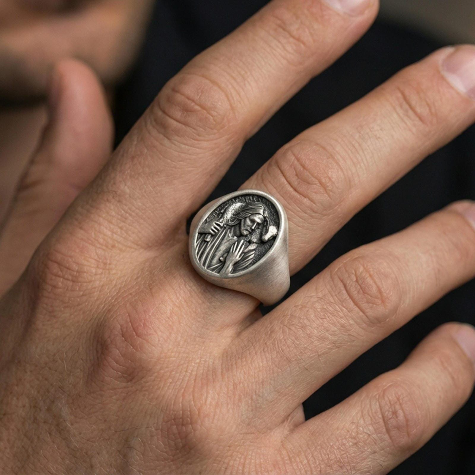 Oxidized 925 sterling silver Jesus Good Shepherd ring worn on finger, Christ carrying lamb relief signet
