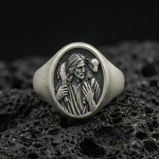 Oxidized 925 sterling silver Jesus Good Shepherd signet ring on volcanic rock, Christ carrying lamb relief face