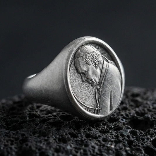 Oxidized 925 sterling silver Pope portrait signet ring on volcanic rock, Catholic faith medal style oval face