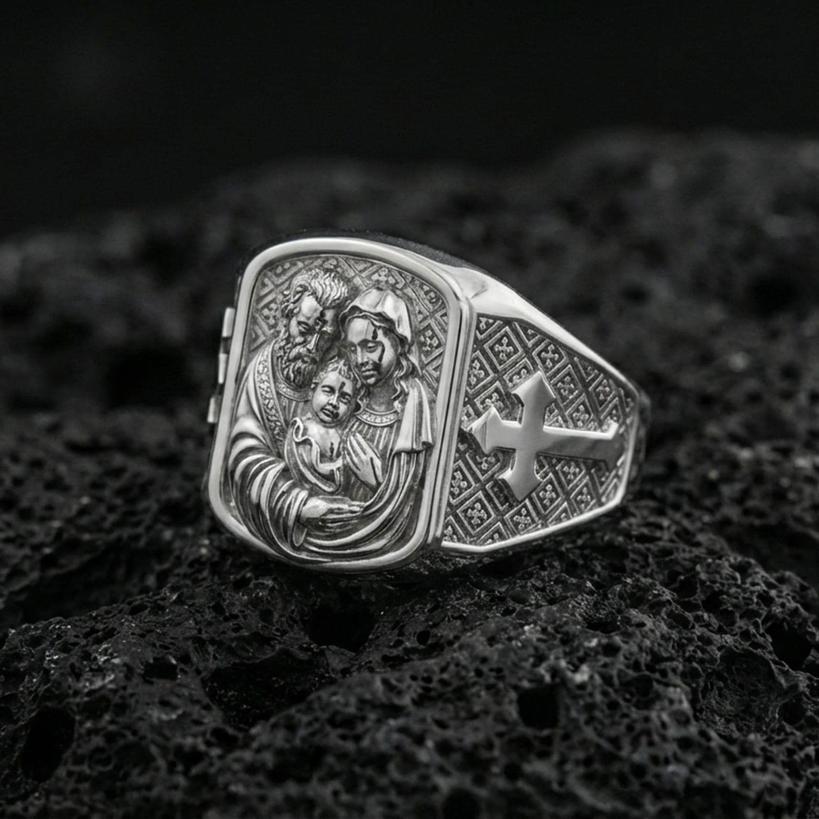 Polished silver Holy Family signet ring on porous volcanic stone, family portrait engraving and cross side panel