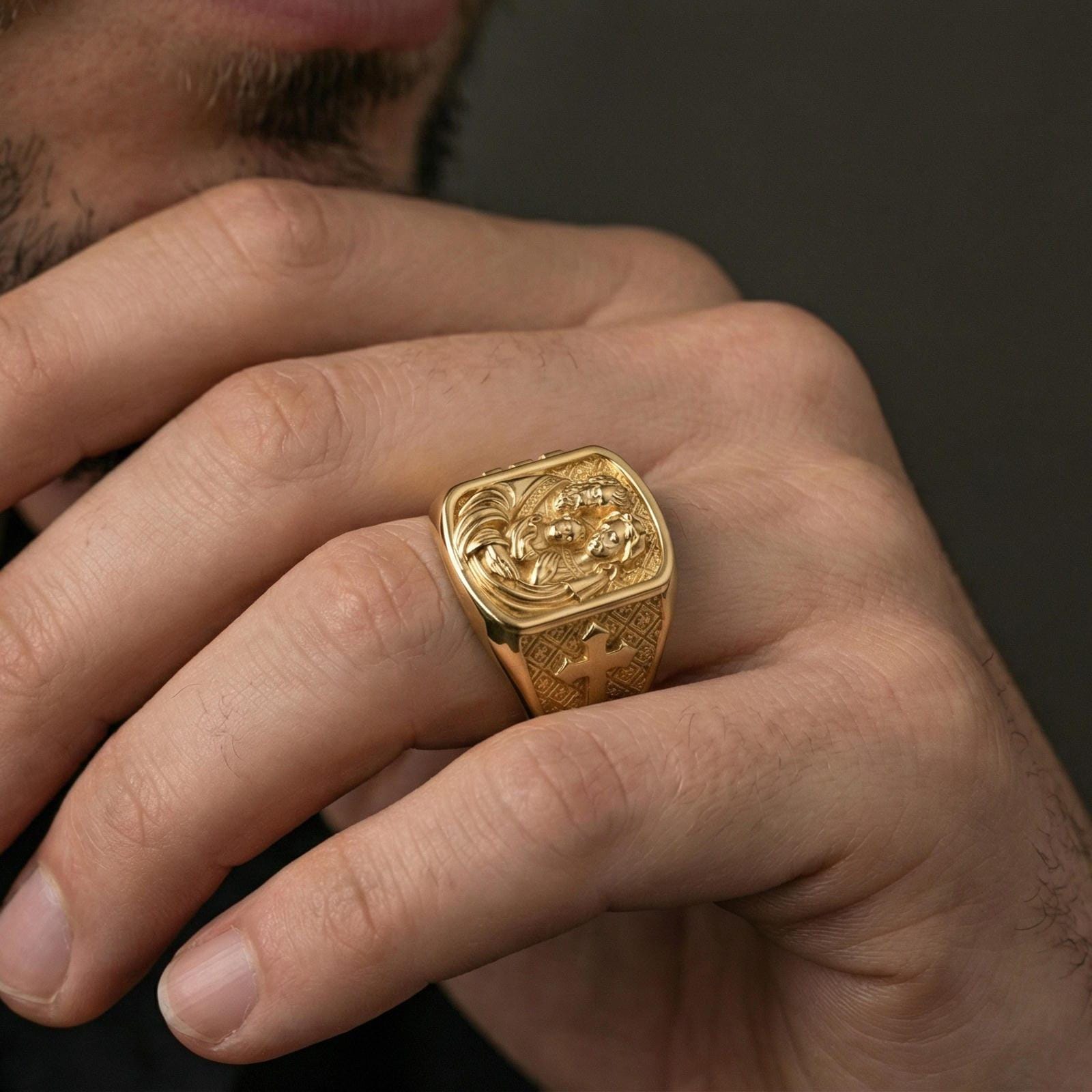 Gold plated Holy Family ring worn on finger, Mary Joseph and Jesus relief with cross motif band