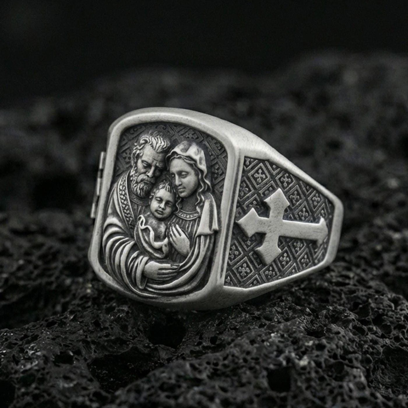 Oxidized 925 sterling silver Holy Family ring on volcanic rock, Mary Joseph and Child relief with cross band
