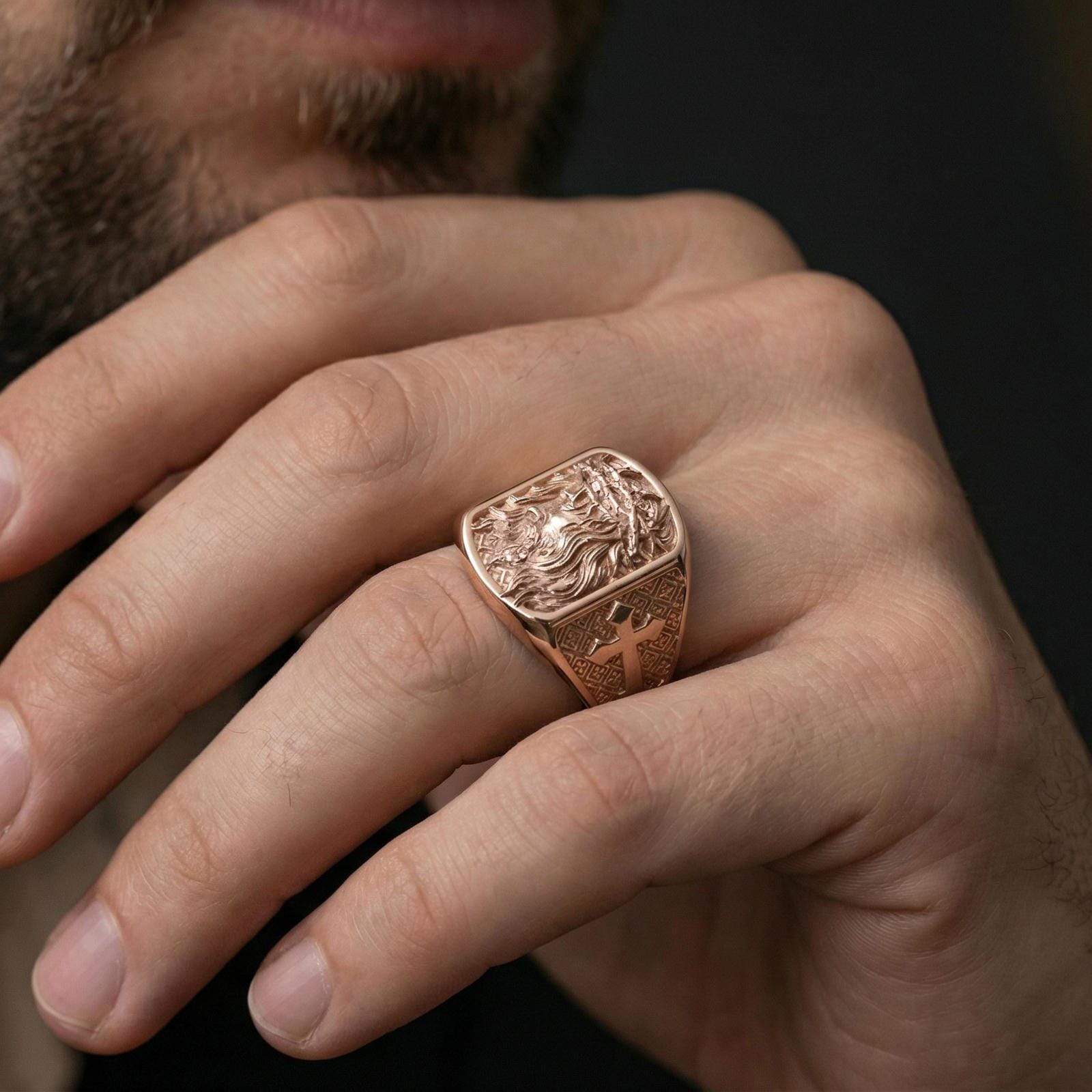 Rose gold plated Jesus of Nazareth ring worn on finger, Christ portrait relief with cross pattern band