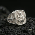 Load image into Gallery viewer, Polished silver Saint Anthony signet ring on porous volcanic stone, detailed saint and Child Jesus engraving with cross motif side
