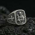 Load image into Gallery viewer, Oxidized 925 sterling silver Saint Anthony ring on volcanic rock, saint holding Child Jesus relief with cross side panel
