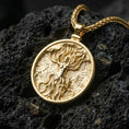 Load image into Gallery viewer, Gold plated tree of life goddess pendant showcased on volcanic rock as a symbol of creation and vitality

