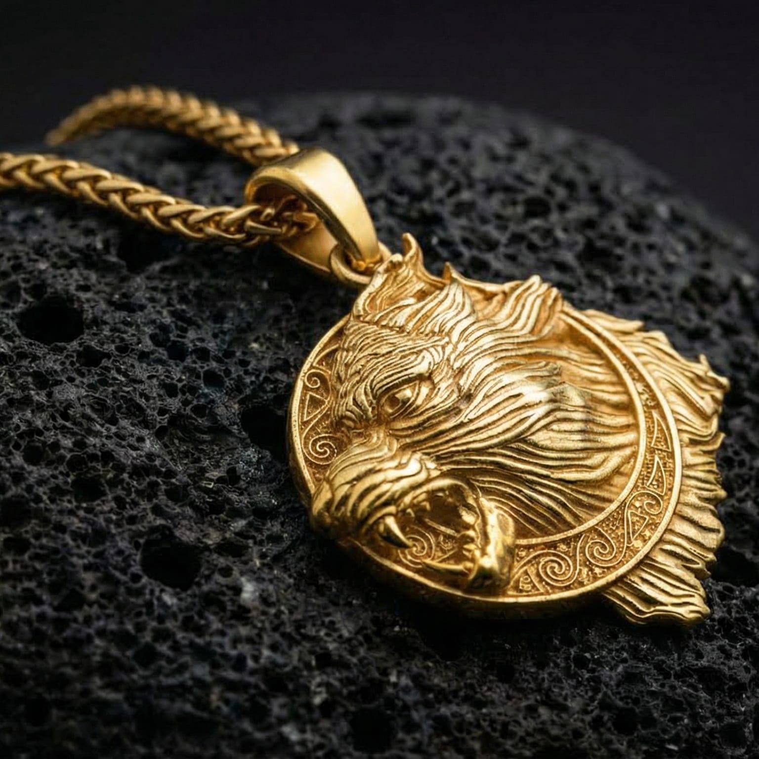 Gold plated Fenrir wolf pendant showcased on volcanic rock as a symbol of Viking strength and untamed power