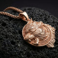 Load image into Gallery viewer, Rose gold plated Fenrir wolf pendant necklace presented on volcanic rock surface with bold Nordic myth aesthetic
