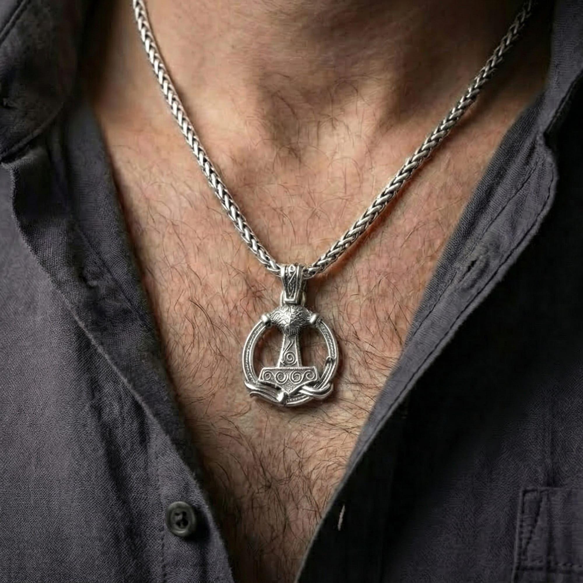 Polished silver Viking Mjölnir amulet worn on chest highlighting Norse mythology symbolism