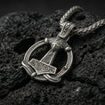 Load image into Gallery viewer, Oxidized Thor’s Hammer Mjölnir pendant necklace photographed on volcanic rock with detailed Norse rune engraving
