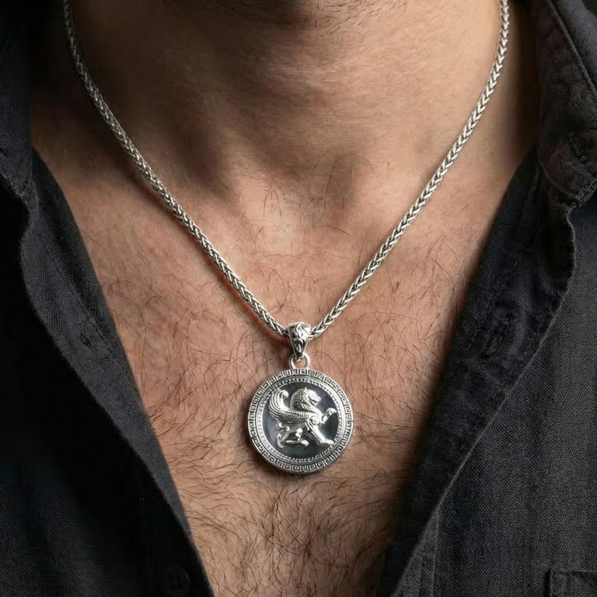 Polished silver mythical winged lion medallion worn on chest highlighting protection and strength symbolism