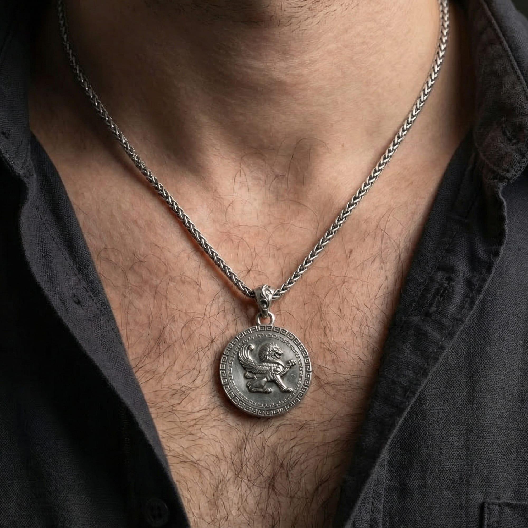 Oxidized winged lion pendant necklace worn on male model as a guardian amulet talisman