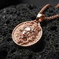 Load image into Gallery viewer, Rose gold plated Medusa mythology pendant presented on volcanic rock surface with dark classical aesthetic
