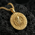 Load image into Gallery viewer, Gold plated Cthulhu pendant showcased on volcanic rock as a symbol of cosmic horror and ancient power

