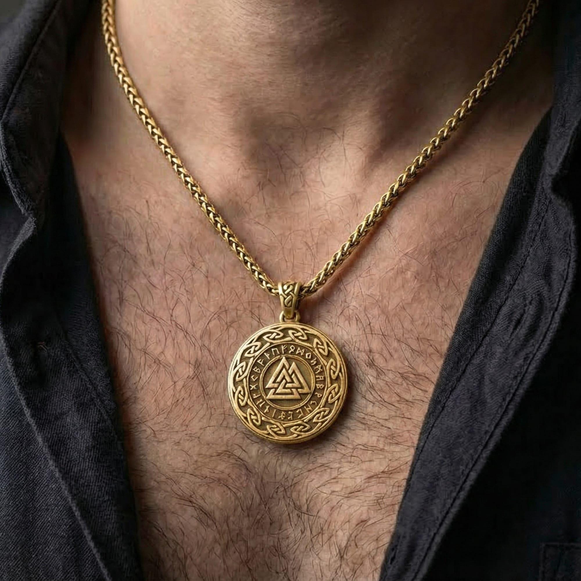 Gold plated Valknut pendant necklace worn by man as bold Viking statement jewelry