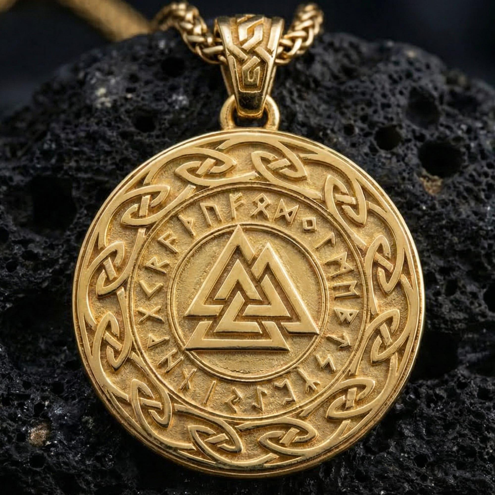Gold plated Valknut pendant showcased on volcanic rock as a symbol of Odin, destiny, and warrior honor