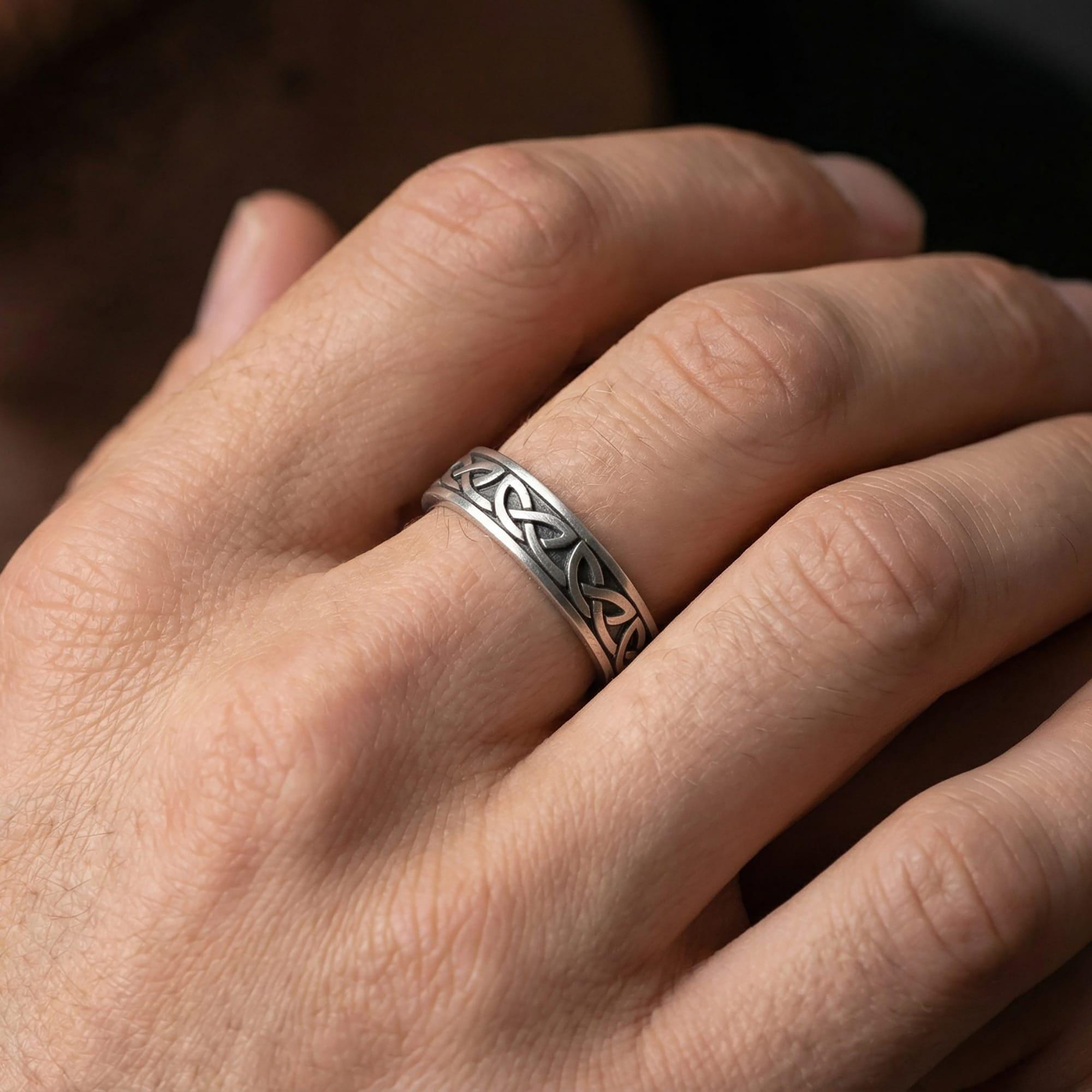 Oxidized Celtic knot ring worn on finger as a timeless symbol of eternal bond and strength