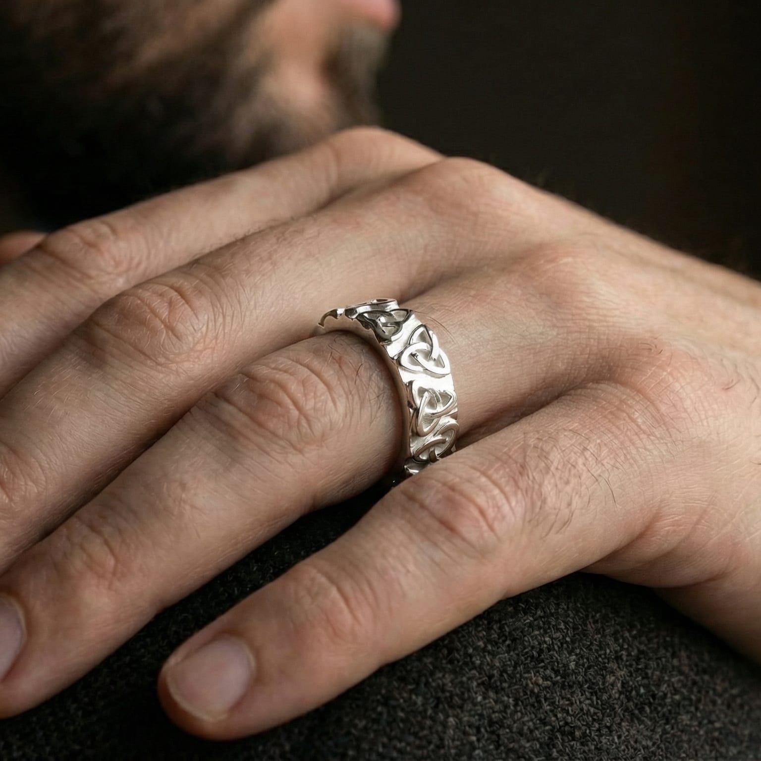 White gold Celtic eternity band ring worn on hand showing Irish knotwork details
