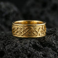 Load image into Gallery viewer, Gold plated Celtic braid ring showcased on volcanic rock with raised knotwork texture for a bold heritage statement wedding band
