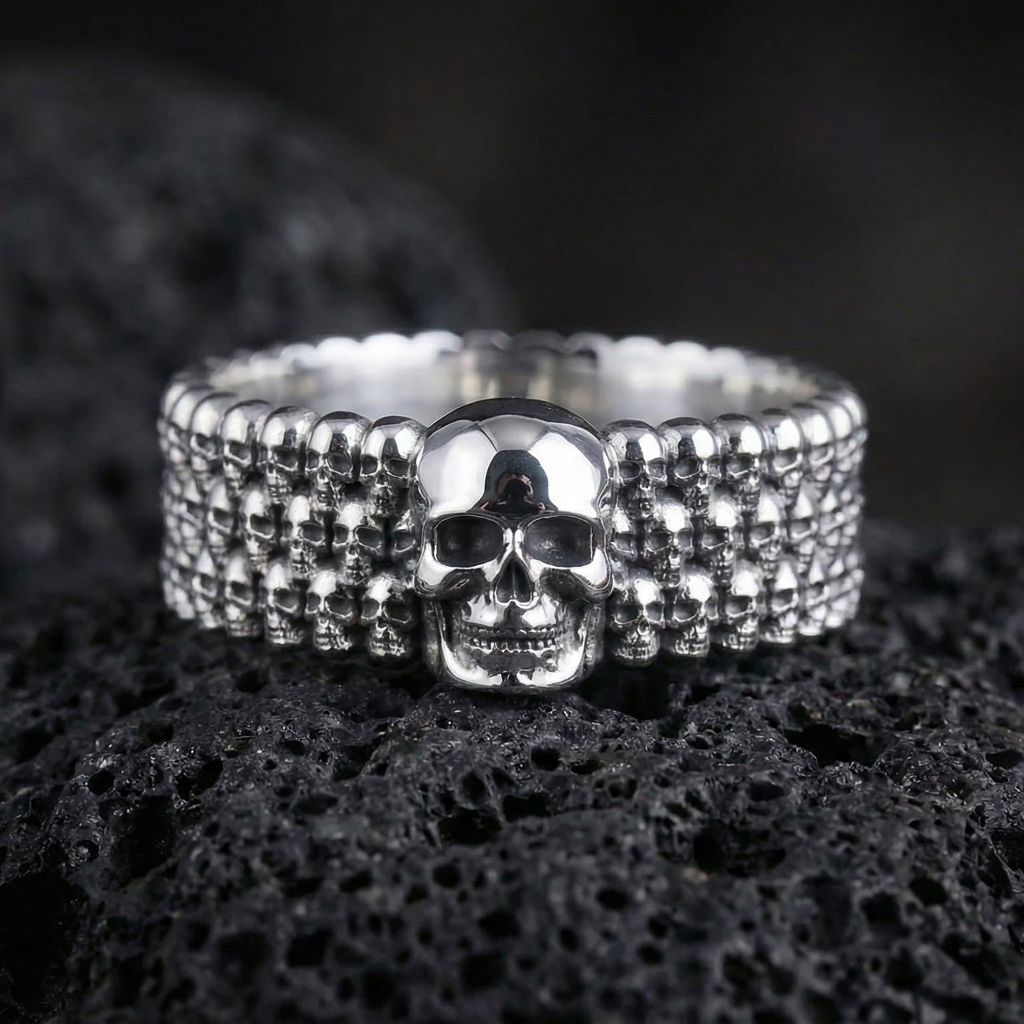 Polished silver faceted wedding band displayed on volcanic stone highlighting crisp angular reflections and modern minimalist cut