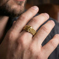 Load image into Gallery viewer, 7. Gold plated faceted wedding band worn by man as a contemporary luxury ring with strong architectural presence
