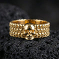 Load image into Gallery viewer, Gold plated geometric prism ring showcased on volcanic rock with luxury light play and architectural statement profile
