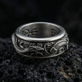 Load image into Gallery viewer, Oxidized spinning dragon and carp fish ring photographed on volcanic rock featuring high-relief oriental myth texture and rotating band design
