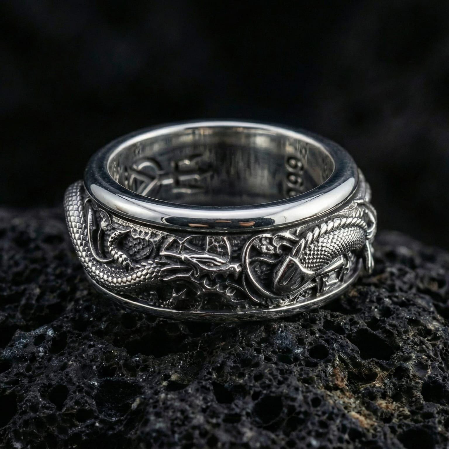 Polished silver dragon carp spinner ring displayed on volcanic stone highlighting detailed scales waves and smooth fidget rotation