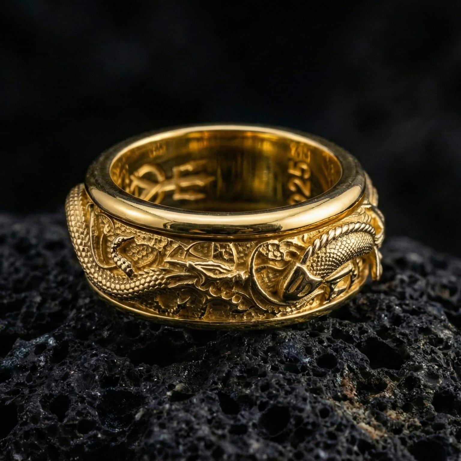 Gold plated dragon and koi inspired spinner ring showcased on volcanic rock symbolizing power prosperity and transformation