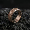 Load image into Gallery viewer, Rose gold plated Japanese kumo cloud band ring presented on volcanic rock surface, emphasizing premium contrast, intricate swirl detailing, and elegant silhouette
