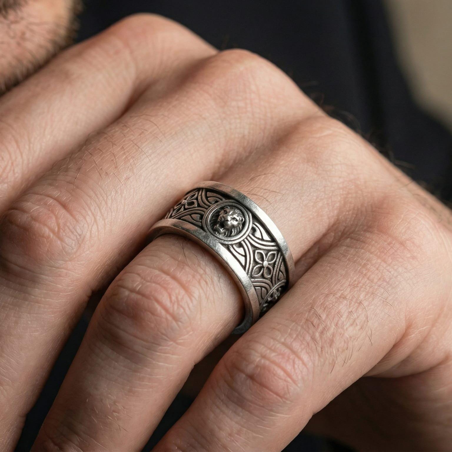 Oxidized lion head band ring worn on finger as a bold protector symbol with antique patina depth and strong everyday presence