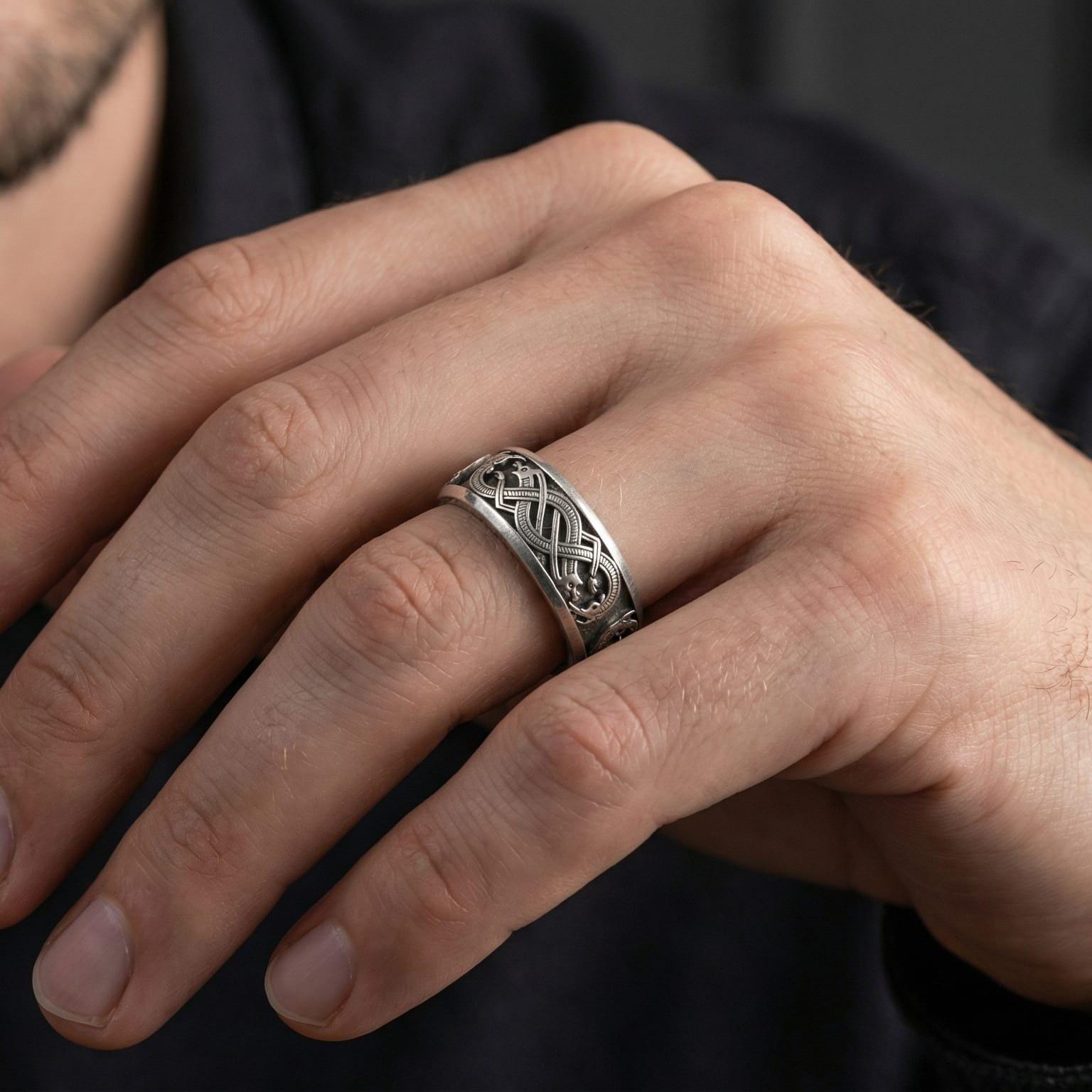 Oxidized Slavic dragon ring worn on finger as a rugged pagan statement band with dark medieval character