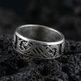 Load image into Gallery viewer, Oxidized Slavic dragon knotwork ring photographed on volcanic rock with engraved serpent pattern and pagan heritage styling

