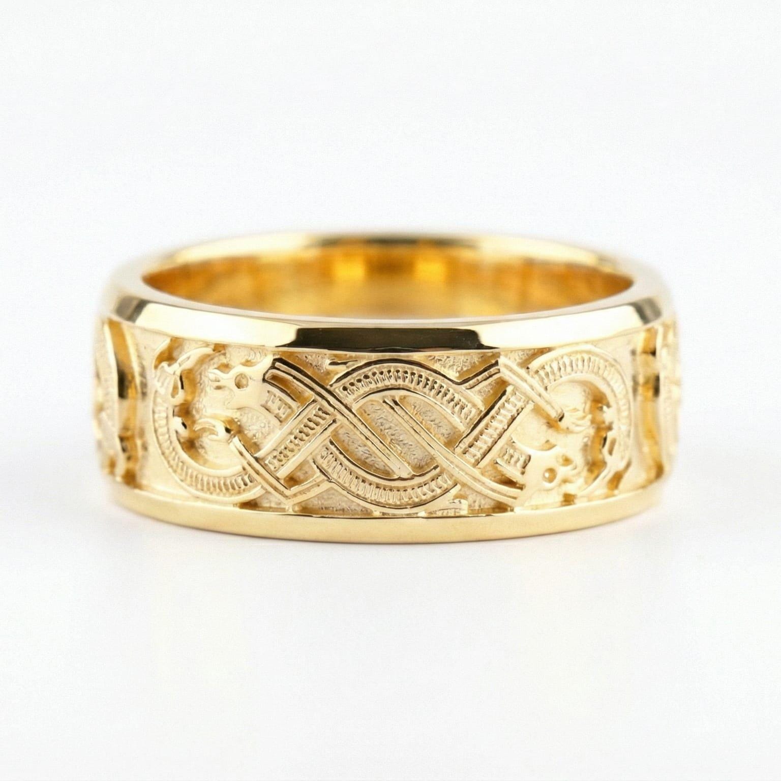 Gold Slavic dragon motif ring displayed on a white surface highlighting Celtic-style knot details and bold mythology aesthetic