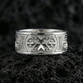 Load image into Gallery viewer, Polished silver crusader Maltese cross ring displayed on volcanic stone background, highlighting raised medieval cross motif with ornamental border engraving
