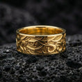 Load image into Gallery viewer, Gold plated wave motif sterling silver band ring showcased on volcanic rock with bold ocean-inspired engraving and premium statement finish
