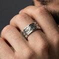 Load image into Gallery viewer, Polished silver engraved wave band ring worn on hand, styled as a sleek minimalist wedding ring with elevated vintage geometry
