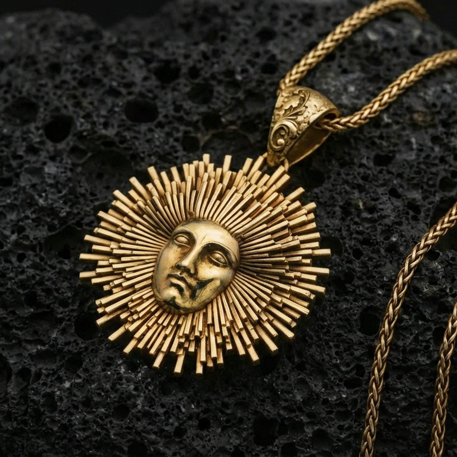 Gold plated Helios sun pendant on volcanic rock, radiant sunburst medallion with face relief and braided chain