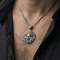 Load image into Gallery viewer, Oxidized 925 sterling silver Helios sun pendant worn on neck, sunburst rays and face relief on braided chain
