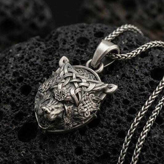 Oxidized 925 sterling silver Fenrir wolf pendant on volcanic rock, Norse Viking necklace with Celtic knotwork and wolf head relief