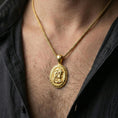 Load image into Gallery viewer, Gold plated Medusa coin pendant worn on neck, Greek mythology medallion necklace with Greek key border and raised portrait relief
