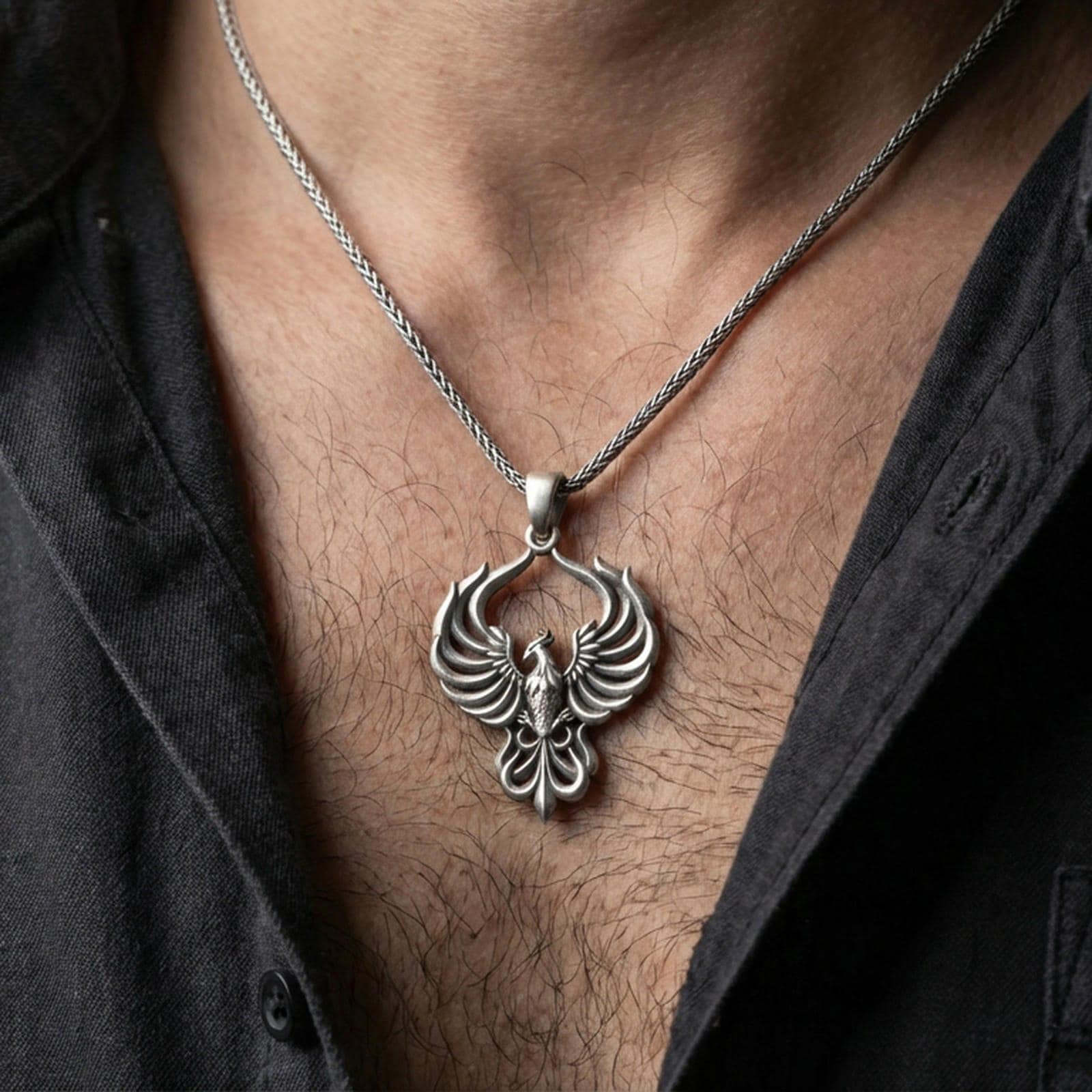 Oxidized 925 sterling silver phoenix pendant worn on neck, openwork wings necklace with statement firebird silhouette
