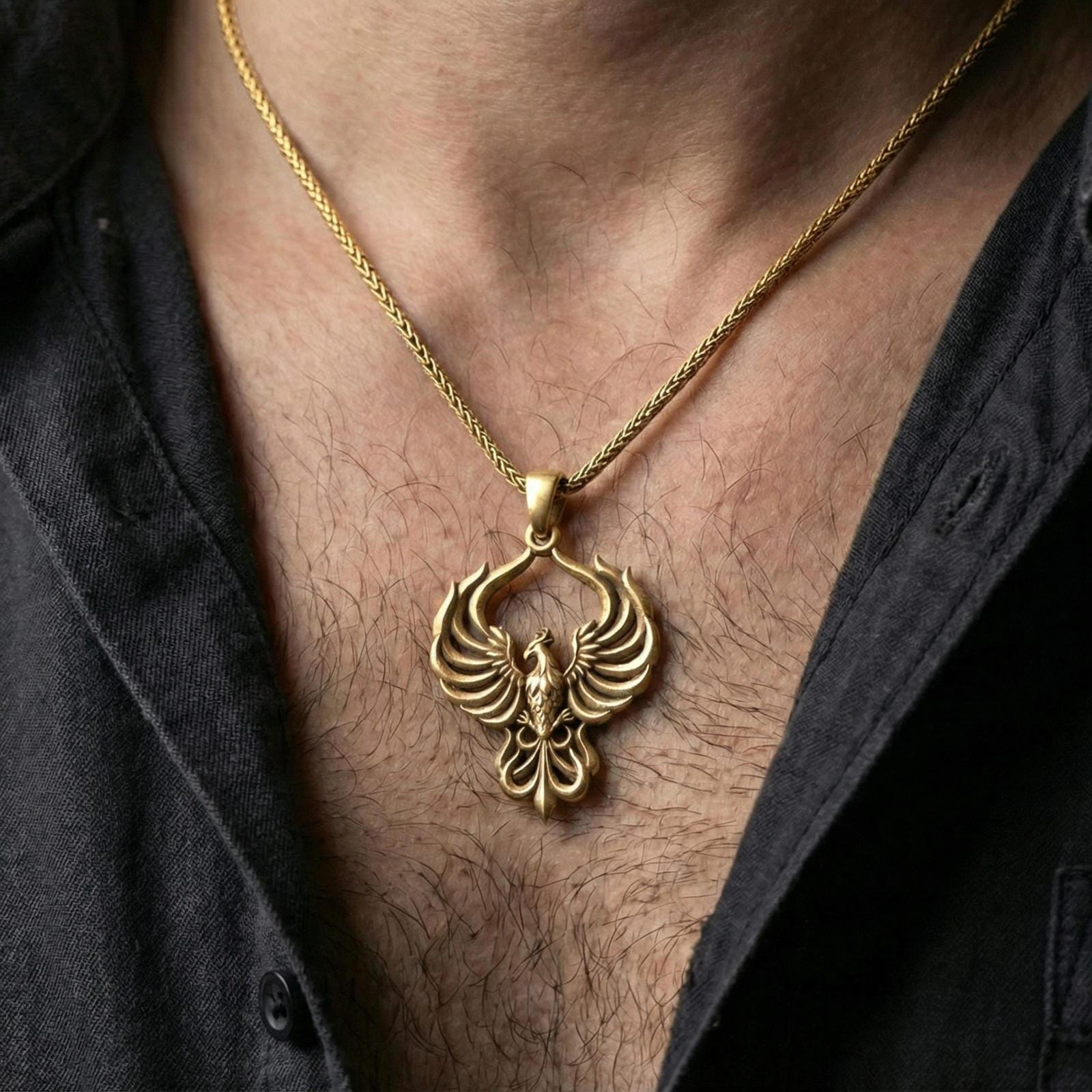 Gold plated phoenix pendant worn on neck, firebird necklace with luxury glow and sculpted wing contours