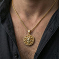 Load image into Gallery viewer, Gold plated medusa coin pendant worn on neck, greek gorgon necklace with bold shine and sculpted texture
