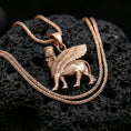 Load image into Gallery viewer, Rose gold plated lamassu necklace on dark volcanic stone, ancient Mesopotamian guardian spirit pendant with sculpted wings
